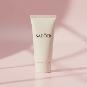 SADOER sunscreen tube displayed in a simple, well-lit studio setting.