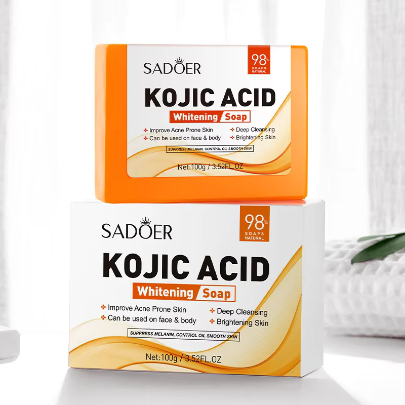 SADOER Kojic Acid Soap Bar resting on its white and orange product packaging box.