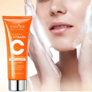 SADOER Vitamin C Facial Cleanser tube beside a person applying the brightening foaming face wash.