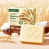 SADOER Oat Exfoliating Soap Bar and packaging displayed with natural wheat and rustic wood.