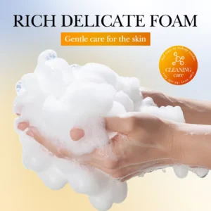Hands holding the rich, delicate foam of a SADOER Turmeric Soap Bar for gentle cleansing.
