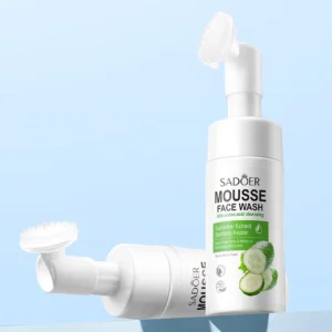Two SADOER Cucumber Facial Cleanser Mousse bottles with silicone massage brushes on blue background.