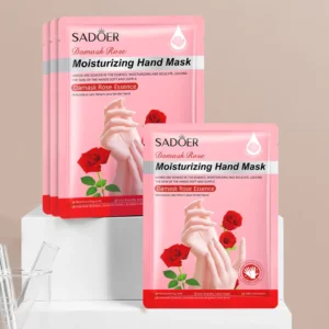 SADOER Damask Rose Hand Mask sachets on a white pedestal for hydrating dry hands.