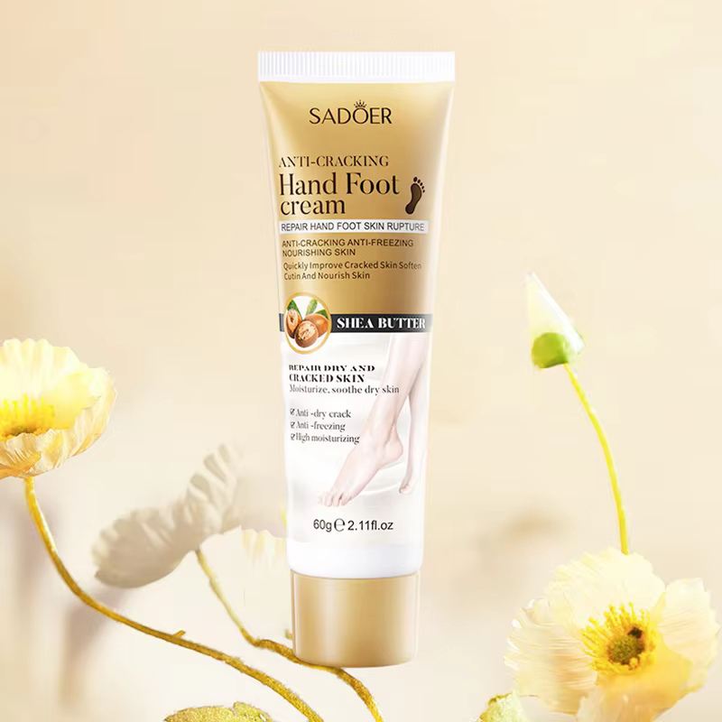 SADOER Shea Butter Anti-Cracking Hand & Foot Cream tube with shea butter among pale yellow flowers.